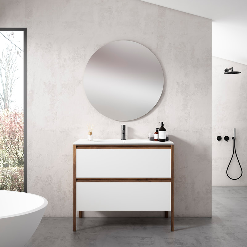 Wooden ico vanity from the tempo series with integrated walnut pulls and a white one-piece countertop in a large bathroom and matte black faucet below a round mirror
