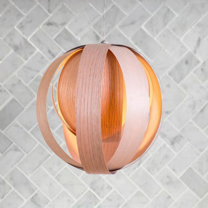 Canadian lighting handmade in Quebec out of local wood veneer by atelier cocotte with a marble herringbone tile wall
