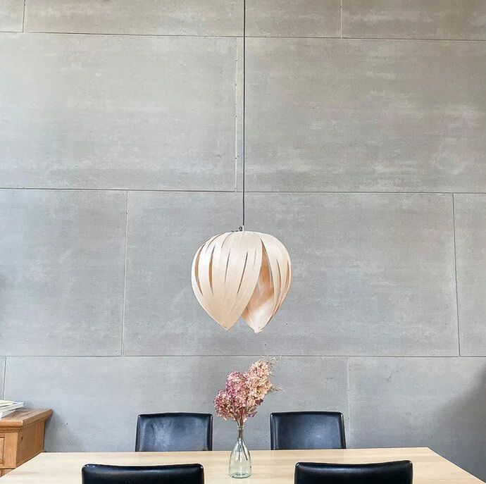 Hand made canadian pendant light out of a modern wood veneer in a loft with industrial concrete wall