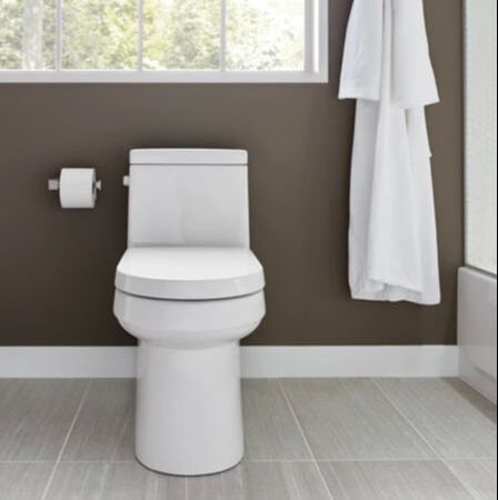 Gerber modern square one piece toilet and grey painted wall with a hanging white bathrobe