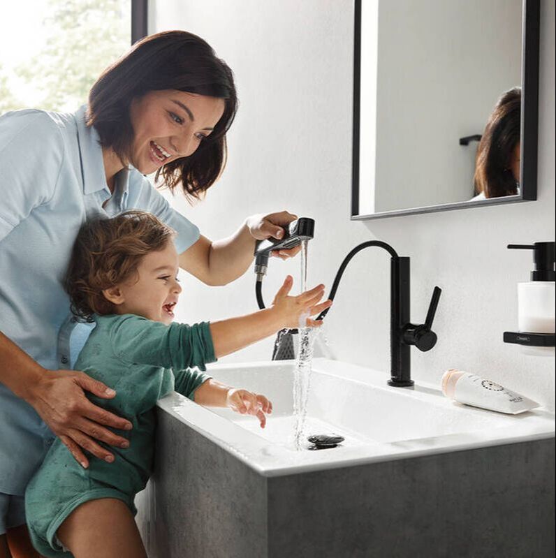 Mother and daughter using the Hansgrohe matte black finoris faucet with pullout spout