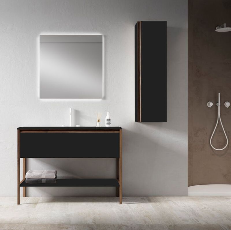 ICO matte black vanity with walnut accents in a modern bathroom with matte white faucets and backlit mirror