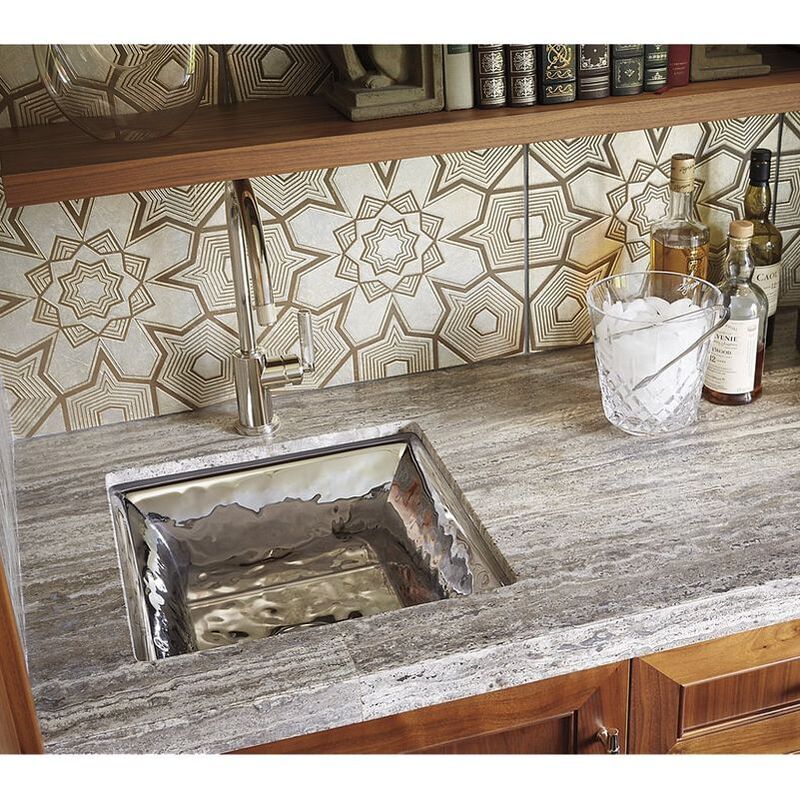 Kallista polished hammered bar sink designed by Mick De Giulio shown with a Vir Styl kitchen faucet and mosaic backsplash