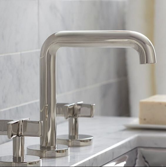 Kallista mid-century modern widespread faucet with cross handles in polished nickel and marble countertops