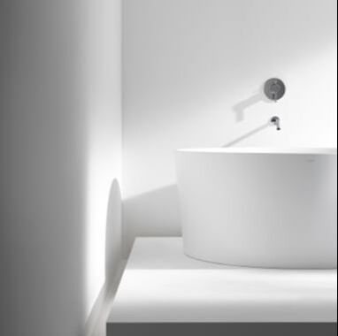 Round freestanding bath by laufen in a modern white bathroom