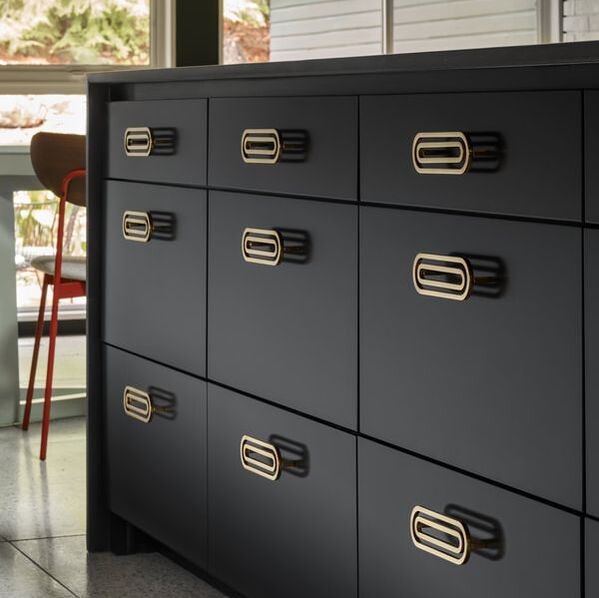 Gold cabinet hardware on black cabinet drawers by Nest studio made from solid brass