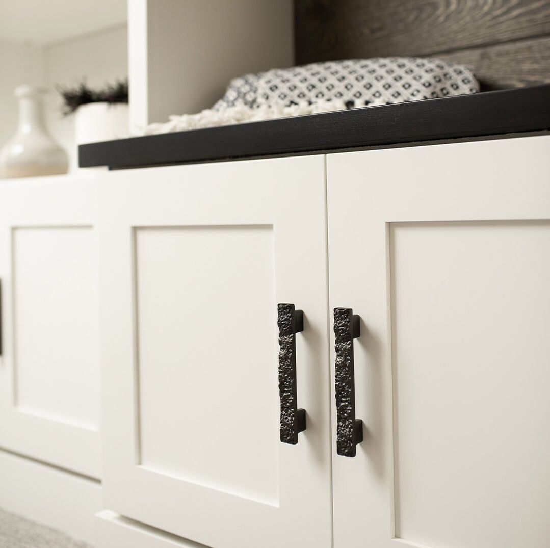 Belwith Keeler black cabinet pulls from the Sandrine collection on white shaker cabinets