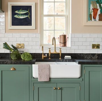 Shaws of Darwen fireclay apron front sink in modern farm house with unlacquered brass bridge faucet