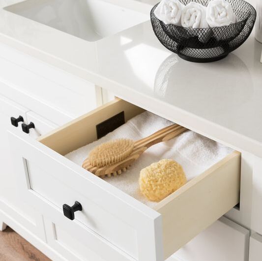 Stonewood vanity with a drawer open and natural bathroom accessories