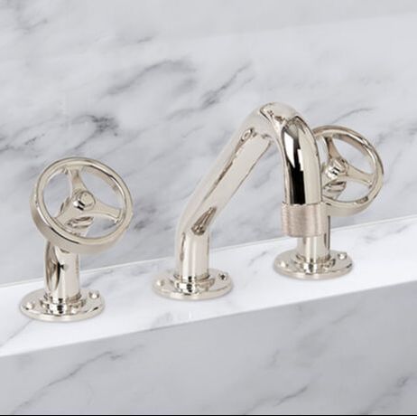 Waterstone argonaut widespread two handle faucet wi thindustrial wheel handles and knurled accents in a polished nickel finish and marble countertop and backsplash 