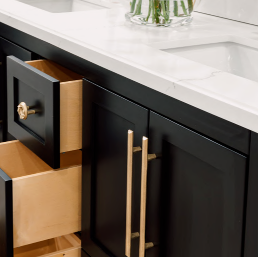 Matte black vanity paired with bronze hardware by shayne fox hardware and a quartz countertop and undermount sinks