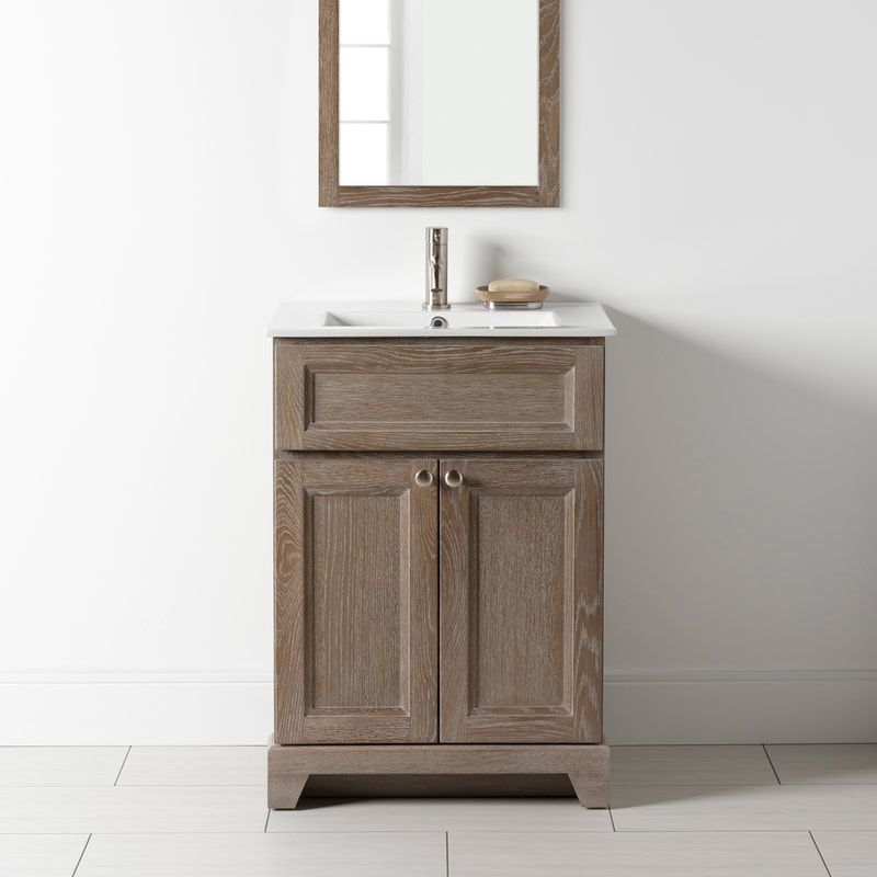 Stonewood premium vanity with wire brushed stain finish, a white quartz countertop and brushed nickel hardware, underneath a rectangular wood mirror.